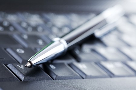 the luxury black pen on computer keyboardの写真素材