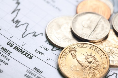 the dollar coin and financial graph