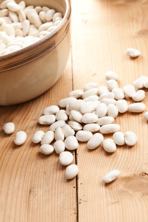 photo shot of white beans on wooden table