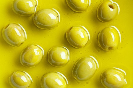 green olives in olive oilの写真素材