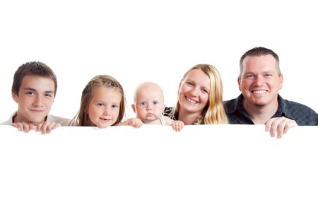 studio shot of happy family behind white boardの写真素材