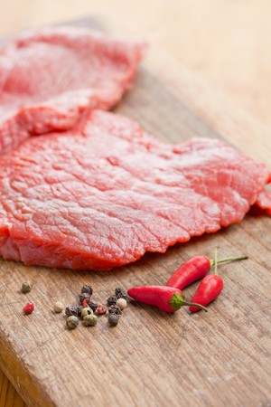 the raw beef steak and chilli pepperの写真素材