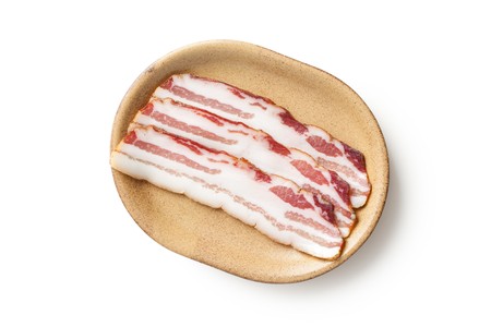 smoked bacon isolated on white backgroundの写真素材