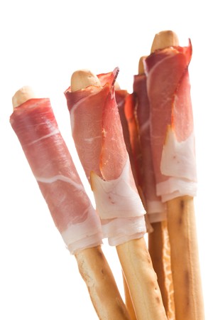 grissini sticks with ham on white backgroundの写真素材