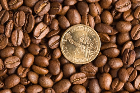 the coin on coffee beans backgroundの写真素材