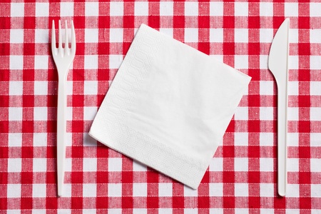 the plastic cutlery on checkered tableclothの写真素材