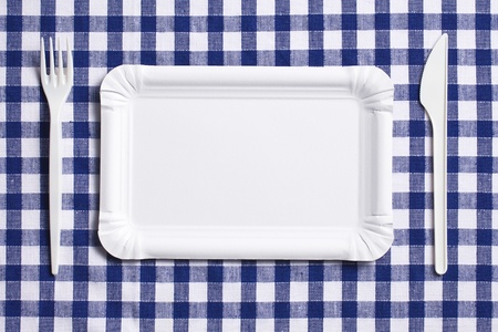 the plastic cutlery on checkered tableclothの写真素材