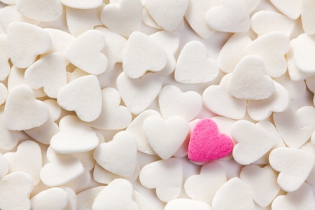 the background with white hearts and one pink heartの写真素材