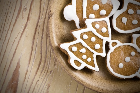 photo shot of christmas gingerbreads on wooden background