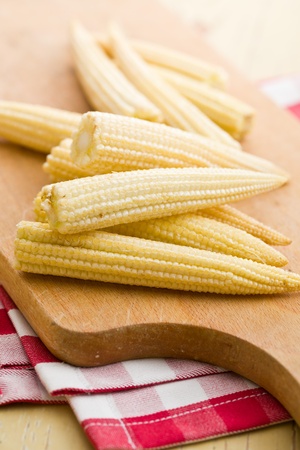 Baby corn cobs on kitchen tableの写真素材
