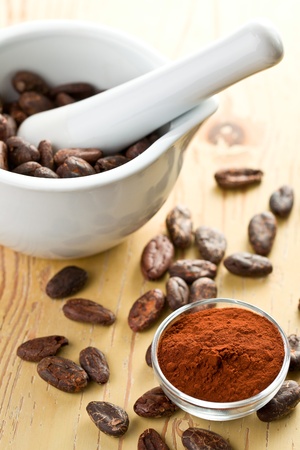 cocoa beans and cocoa powder on wooden tableの写真素材