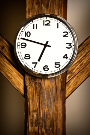 the wall clock hanging on wooden constructionの写真素材
