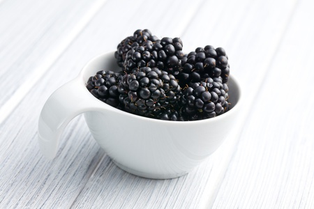 blackberry fruit in bowl on kitchen tableの写真素材