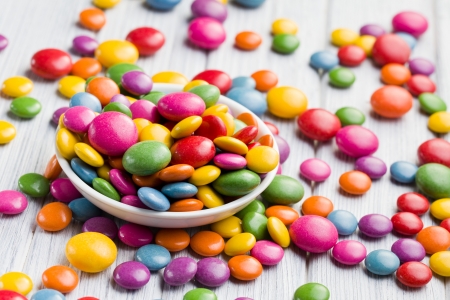 the colored candy in white bowlの写真素材