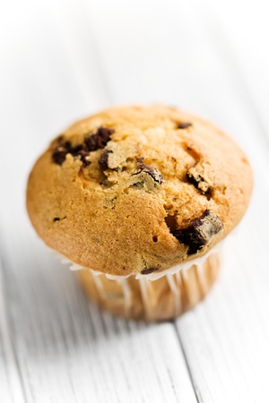 tasty muffin with chocolate on kitchen tabelの写真素材