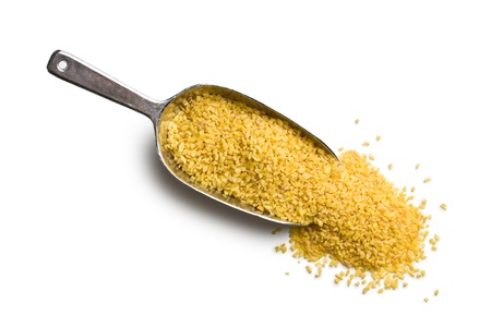 bulgur wheat in metal scoop on white background