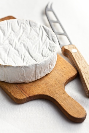 camembert cheese with knife on kitchen tableの写真素材