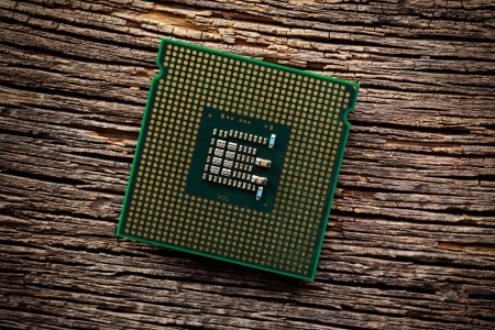 the computer processor on old wooden background