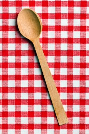 the wooden spoon on checkered tableclothの写真素材