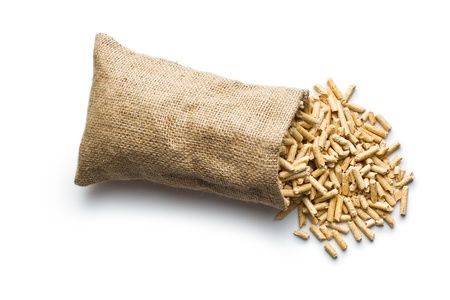 wooden pellets in jute sack on white background