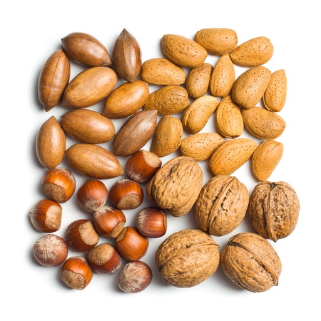 various unpeeled nuts on white background