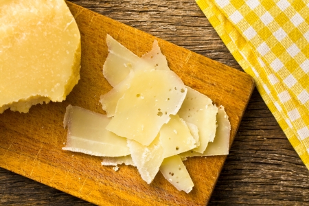 the pieces of Italian hard cheese on a wooden tableの写真素材