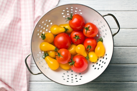 top view of various tomatoes in colanderの写真素材