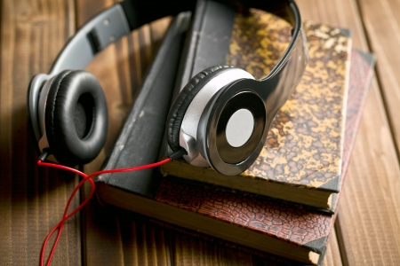 headphones with books on wooden tableの写真素材