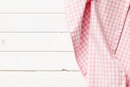 top view of pink checkered napkin on white wooden tableの写真素材