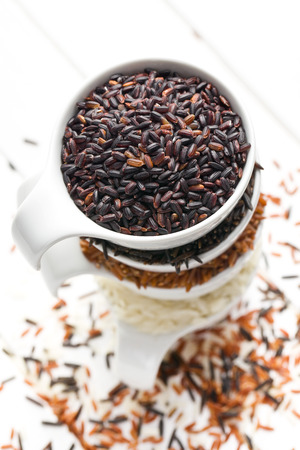 various rice in white ceramic bowlsの写真素材