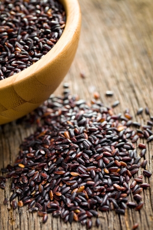 black rice on wooden tableの写真素材