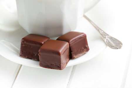chocolate praline on white ceramic saucer