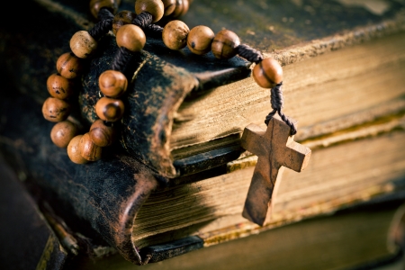 stack of old books with rosary beadsの写真素材