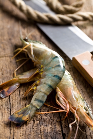 raw tiger shrimps on old woodenの写真素材