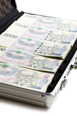 czech money in aluminium case on white backgroundの写真素材