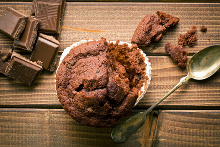 top view of chocolate muffin and chocolate on wooden tableの写真素材