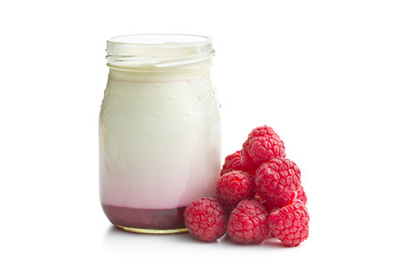 yogurt in jar with raspberries on white backgroundの写真素材