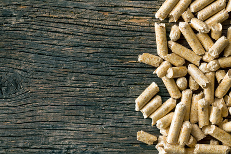 the wooden pellets on old wooden background