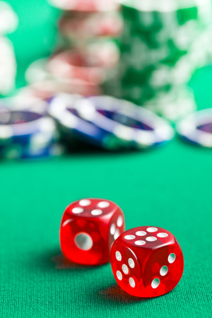  the red casino dice and casino chips on green tableの写真素材