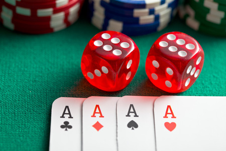  the red casino dice and poker cards on green table