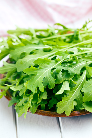 the fresh arugula leaves on plateの写真素材