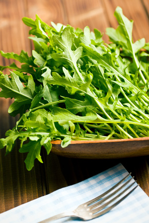 fresh arugula leaves on old wooden tableの写真素材