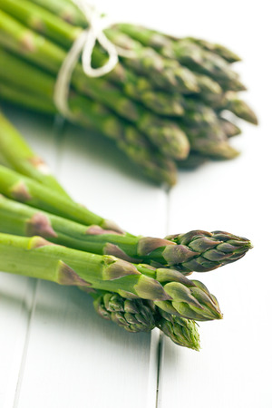 green asparagus on white wooden tableの写真素材