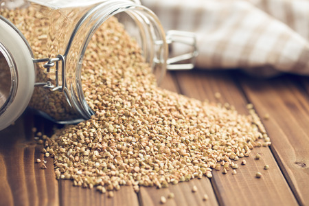 uncooked buckwheat on wooden tableの写真素材