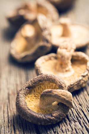 the dried shiitake mushrooms on old wooden tableの写真素材