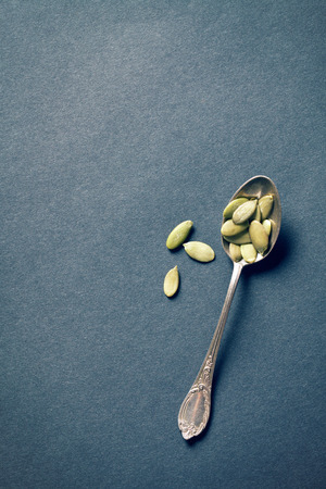top view of pumpkin seeds in silver spoonの写真素材