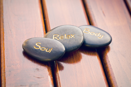 the spa stones on wooden background の写真素材