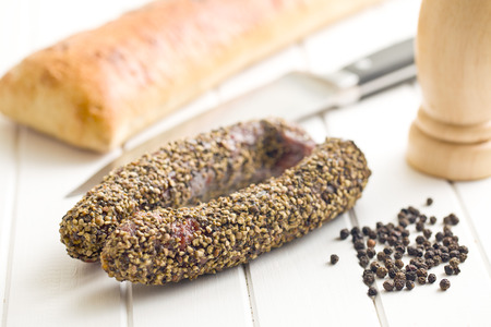 dried sausage with pepper on kitchen tableの写真素材