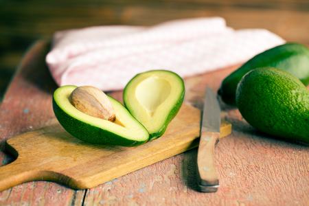 the halved avocados on old wooden table