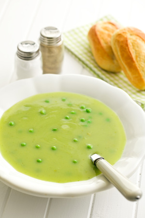 pea soup in plate on kitchen tableの写真素材